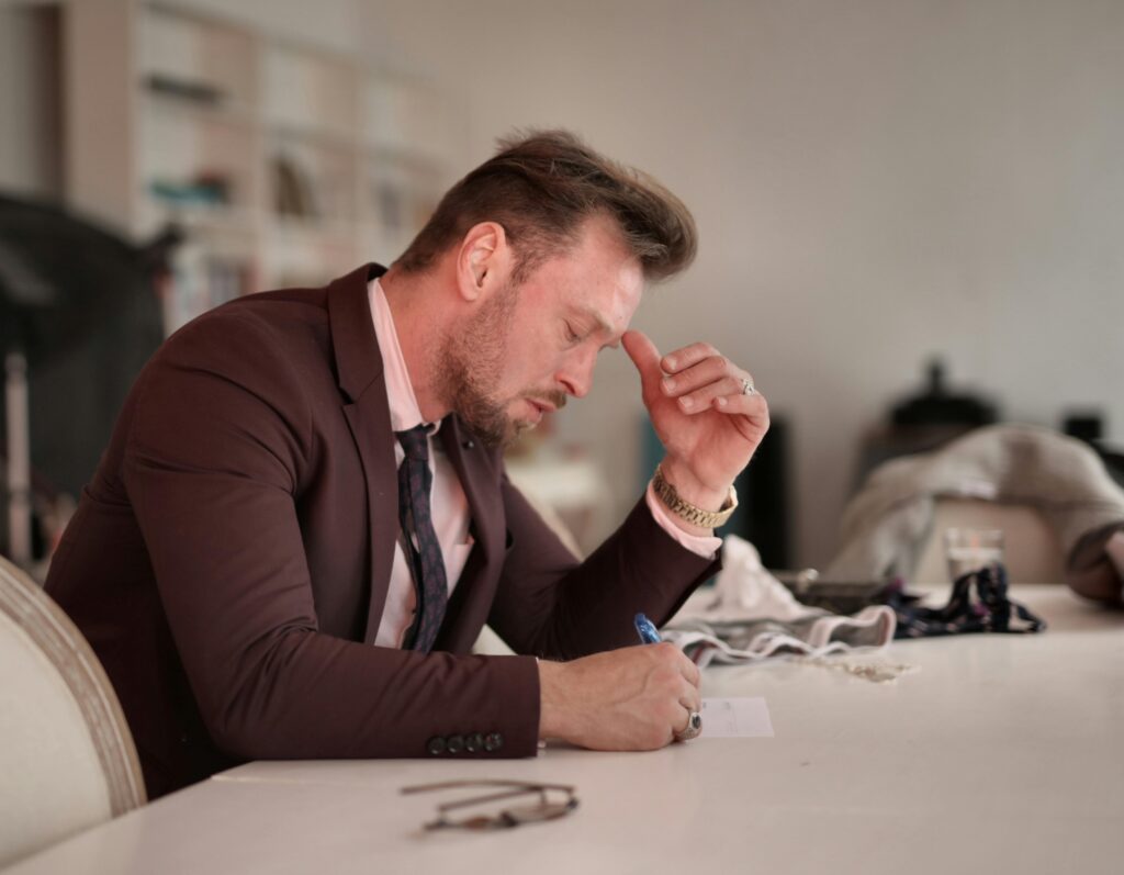 Business owner reviewing notes at home while planning retirement or a major financial decision