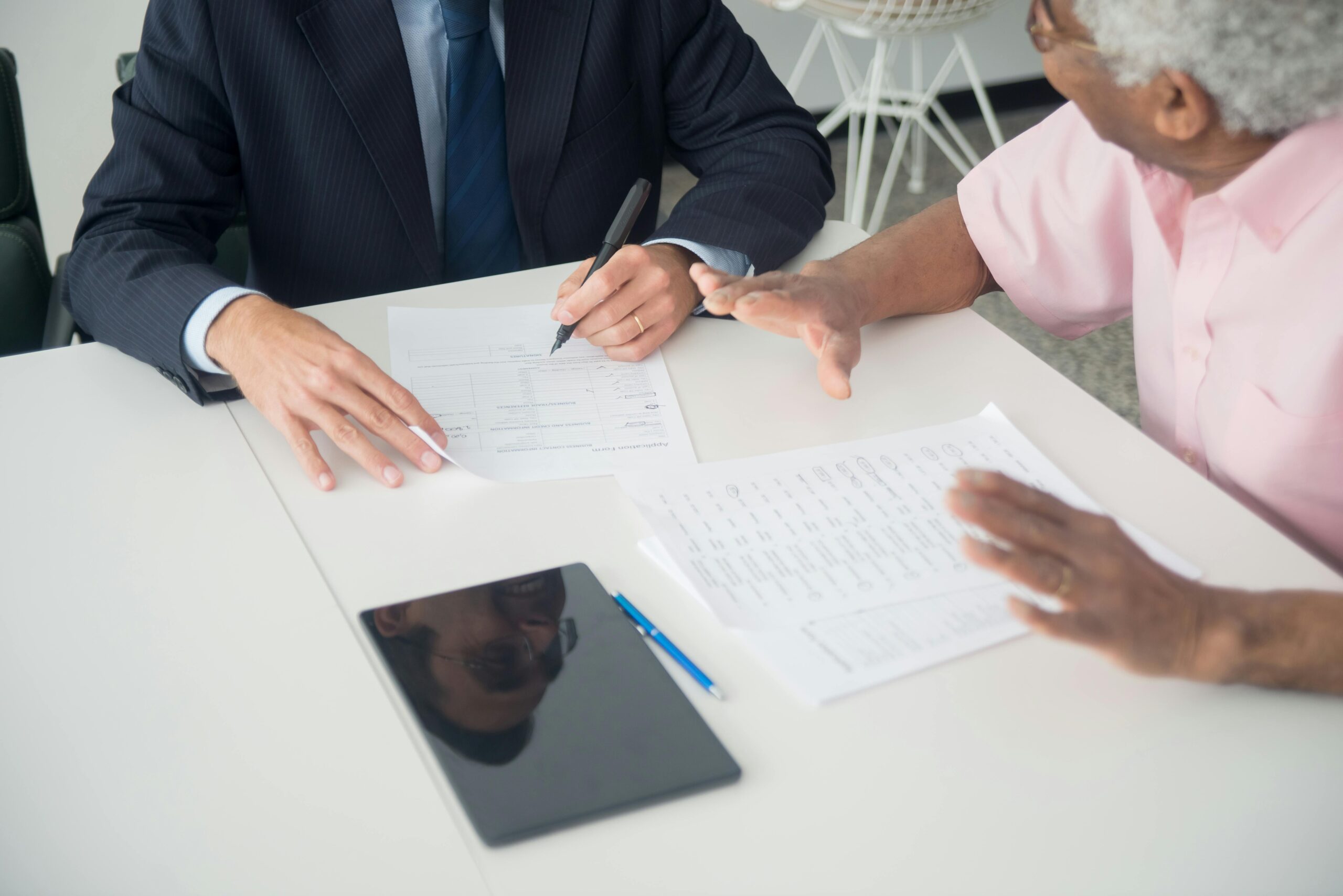 Older man consulting with an adviser about pension planning