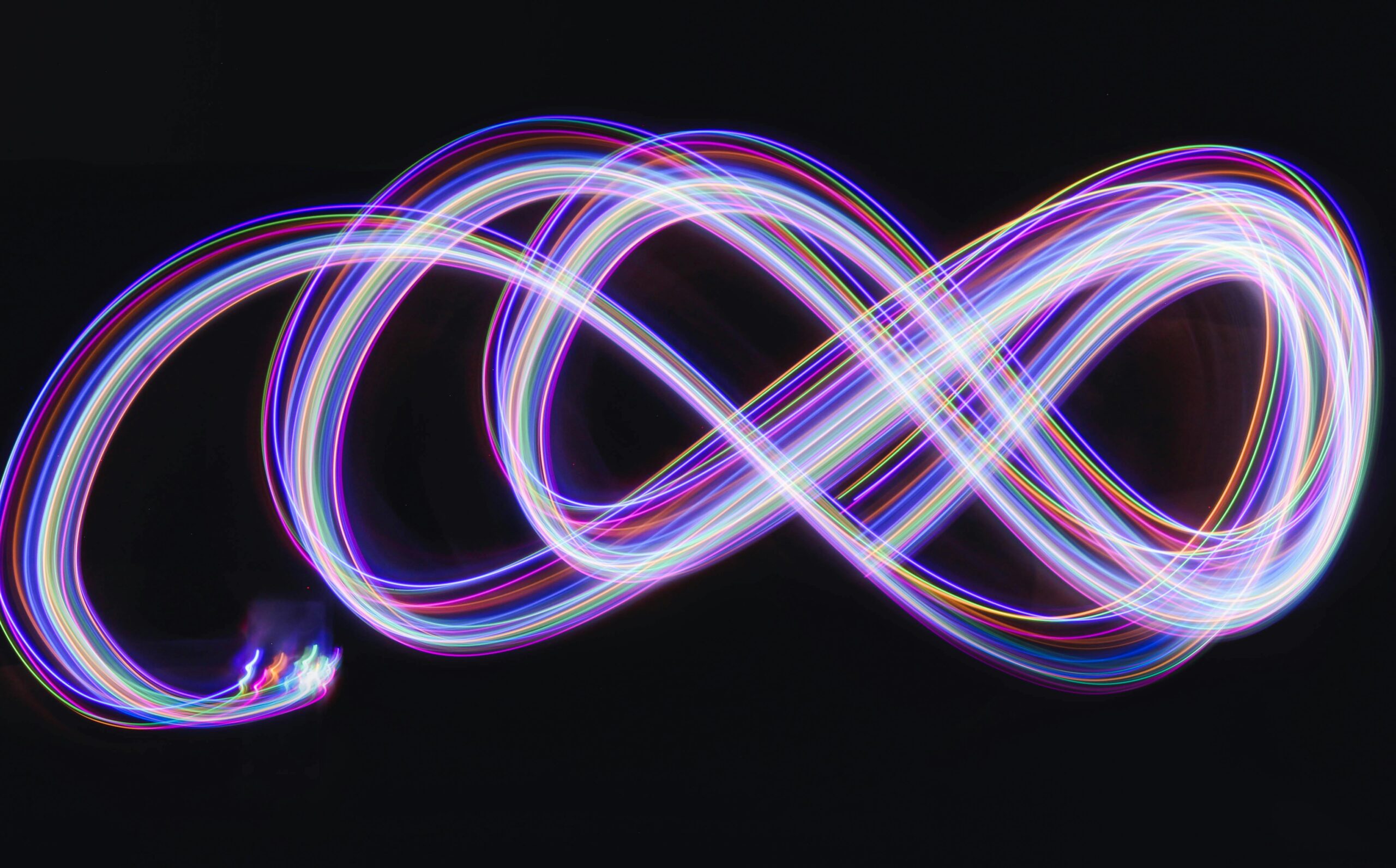 Colourful light streaks on a black background representing financial clarity and forward planning