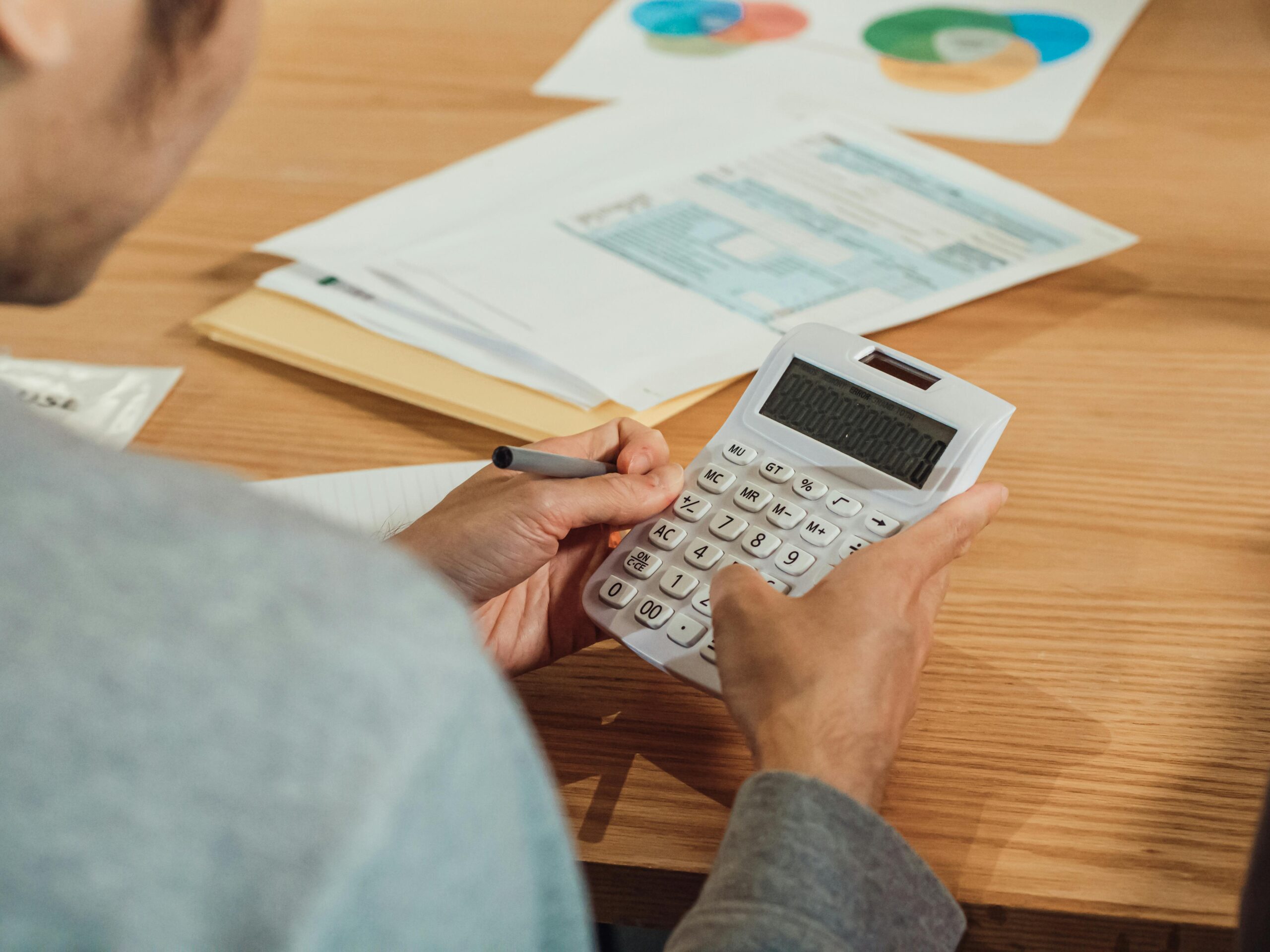 Person using a calculator to review pension and tax-free allowance planning